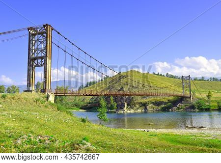 Sunny River Bank Under A Blue Cloudy Sky In The Altai Mountains. Siberia, Russia