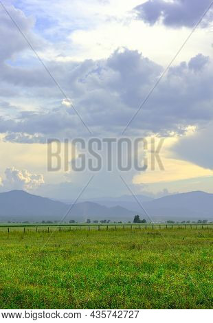Thick Cumulus Clouds In The Evening Over The Mountain Plain. Siberia, Russia