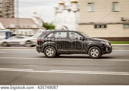 Kia Sorento Suv Moving Fast On The Street Of Moscow. Black Shiny Mid-size Luxury Crossover In Motion