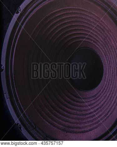 Close-up Of Speaker Membrane On Black Background With Colored Lighting.