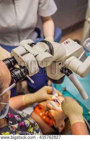 Dental Treatment With A Microscope. Woman Having Teeth Examined At Dentists. Appointment At The Dent