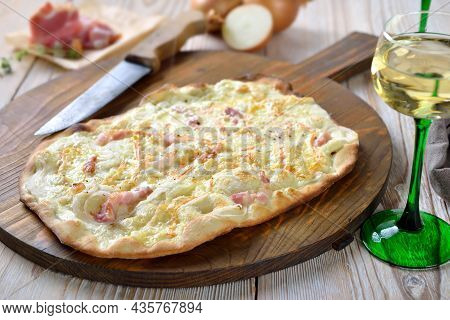 Hearty Tarte Flambée From Alsace With Onions, Smoked Bacon And Munster Cheese Hot From The Oven, Ser