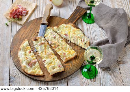 Hearty Tarte Flambée From Alsace With Onions, Smoked Bacon And Munster Cheese Hot From The Oven, Ser