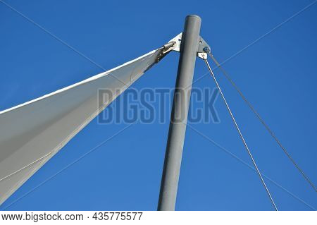 White Tarpaulin Taut, Shading From The Sun And Rain Over The Terrace Of The Restaurant, On The Playg