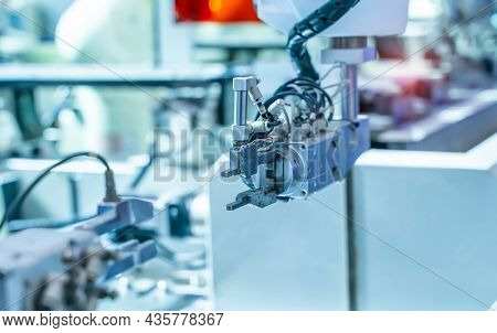 robotic arm catch for electronic assembly line. The robot for smart technology manufacturing process.
