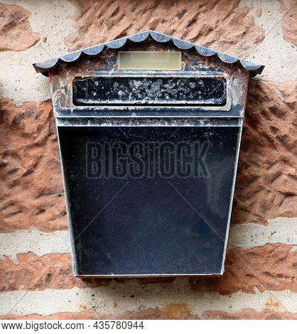 Old Metal Mail Box Situated On A Town Building Wall