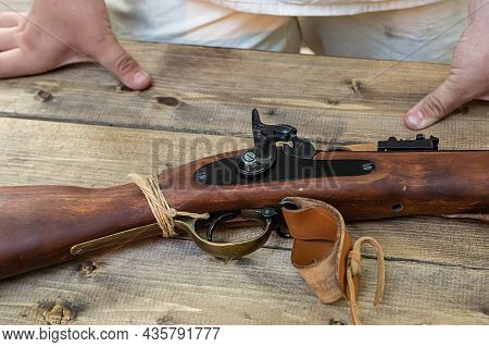 Old Muzzle-loading Weapon, Trigger Traditional Musket On A Wooden Table