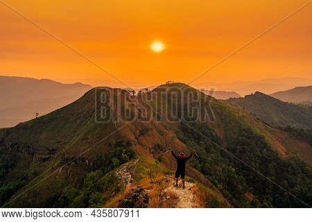 Traveler Man Hiking Enjoying In The Mountains With Backpack At Khao Chang Puak Mountain Thailand.