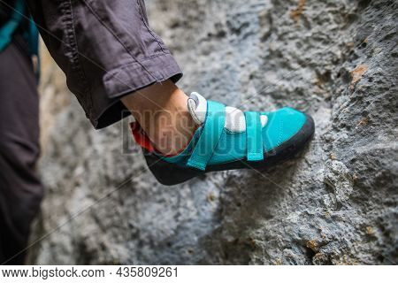 Person Climbing While Wearing Rock Climbing Shoes