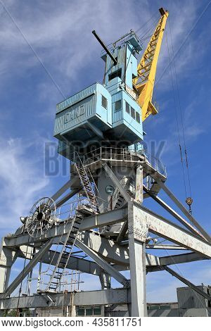 Kazan, Russia - August 7, 2021. Portal Crane Against The Blue Sky Background In The River Port Of Ka