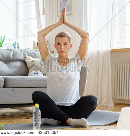 Senior Woman With Closed Eyes, Online Training In Living Room. Exercising With Laptop Watching Fitne
