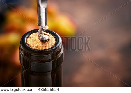 Bottle Wine With Corkscrew. Opening A Wine Bottle With A Corkscrew In A Restaurant. Wine Composition