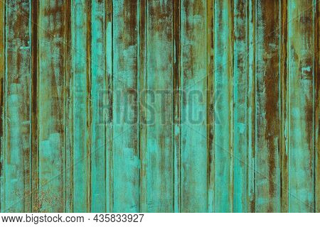 Rusted Corrugated Steel Sheet With Leftovers Of Decayed And Washed Out Green Paint.