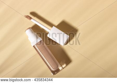 Concealer Cream On A Background With Shadows. Face Corrector On Beige Background With Copy Space. Bl