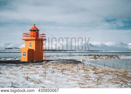Beautiful View Of Orange Colored Lighthouse On The Northcoast Of Iceland, West Iceland In Winter Sea