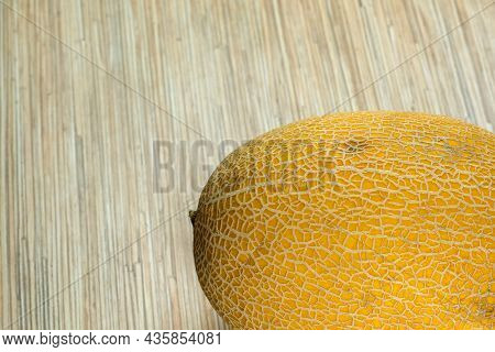 Melon Yellow And Ripe Fruit One-piece Close-up Lies On A Light Background