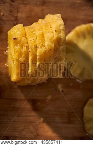 Hands Peeling Freshly Cut Pineapple Slices, Healthy Food.