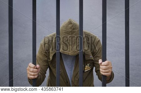Despair Man Bend Down The Head With Holding Metal Fence Bars, Immigrant And Refugee Crisis In Hopele