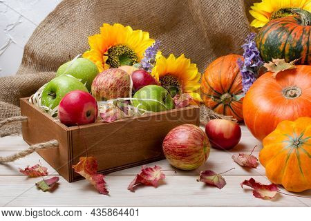Rustic Fall Background With Wooden Box, Pumpkin, Autumn Leaves, Red, Green Apples And Sunflowers Arr