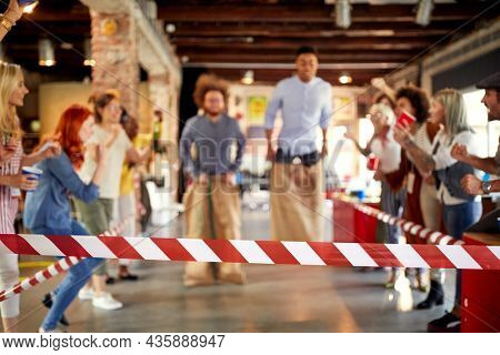 Group of young people having a good time during company's team building event in a cheerfull atmosphere in the office
