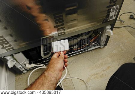 Paris, France - Aug 11, 2021: Pov Male Hand Holding New Wifi Dongle For Home-connect Refrigerators M