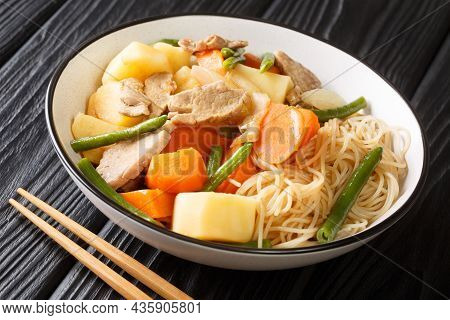 Japanese Meat And Potato Stew Nikujaga Close Up In Bowl On The Wooden Table. Horizontal