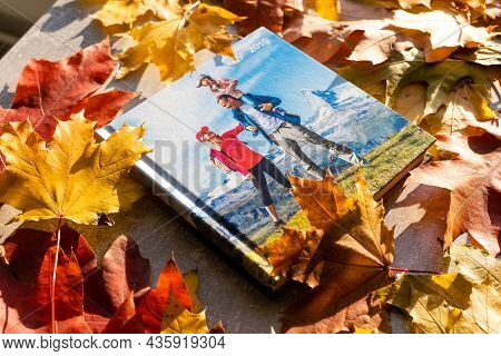 Photobook On The Leaves Background, Closeup Of Photobook, Family Photo Album