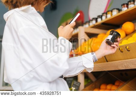 Close-up Cropped Shot Of Unrecognizable Young Woman Choosing Products In Market Walking Along Counte