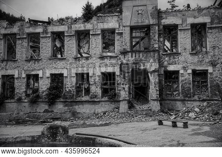 Black And White Photo Of Old Ruined By Mudflow Building With Intricate Stonework, Crashed Roof, Empt