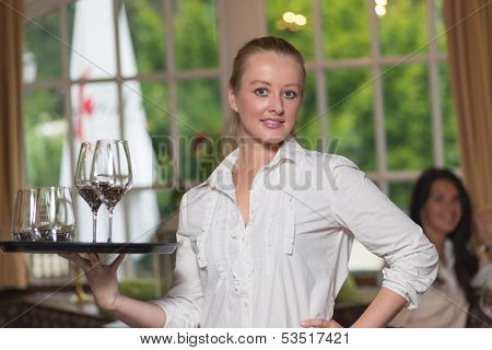 Young Blond Waitress In A Restaurant
