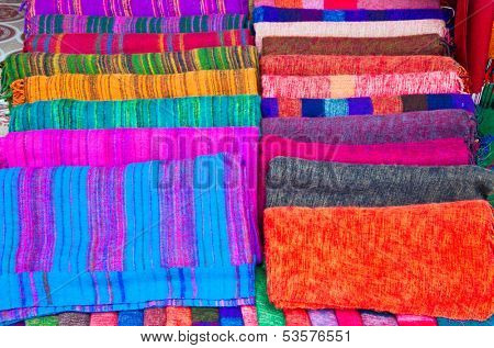 Pile of gentle folded shawls (scarfs) at the market, Pokhara, Nepal.