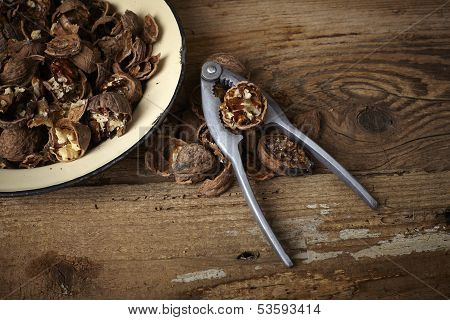 Walnuts Cracked Open With Old Nut Cracker In A Vintage Plate On A Wooden Table