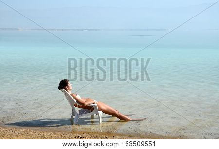 Girl Resting On The Dead Sea