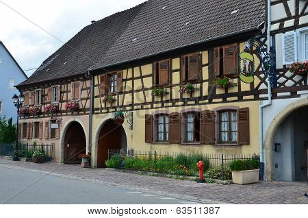 Street with half-timbered medieval houses in Eguisheim village along the famous wine route in Alsace