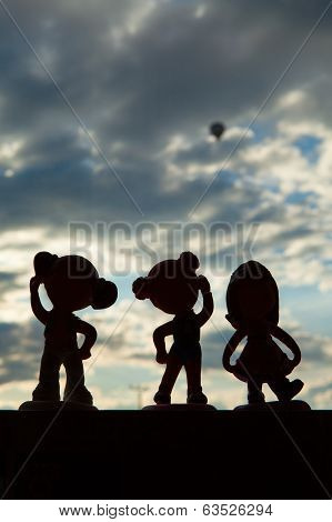 Happy Dolls Silhouettes On The Window Looking At A Balloon