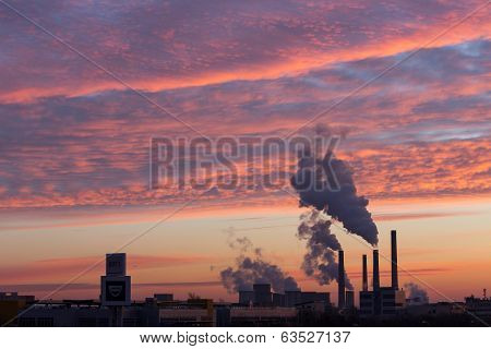 Winter Scenic Of Power Plant With A Burning Red Clouds Behind