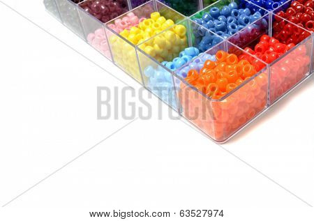Closeup of beads in bins separated for making crafts jewelry