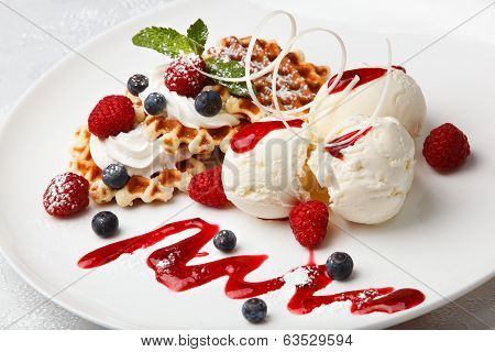 Vanilla ice cream and waffles with fresh berries
