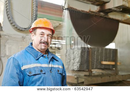 industrial worker at factory on granite or marble 