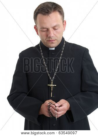 Catholic priest saying his rosary beads 