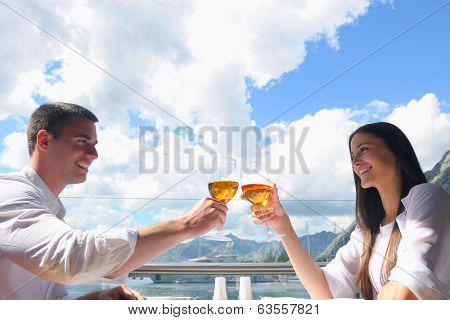 happy young couple having lanch at beautiful restaurant on the beach