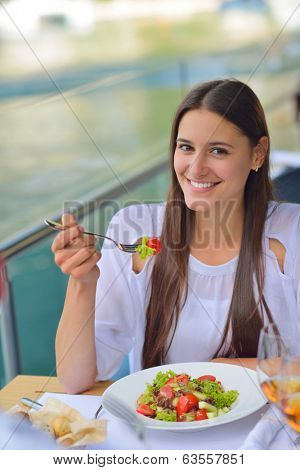 happy young couple having lanch at beautiful restaurant on by the sea on  beach