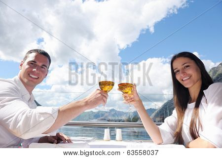 happy young couple having lanch at beautiful restaurant on the beach
