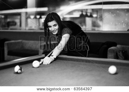 Young brunette girl playing snooker