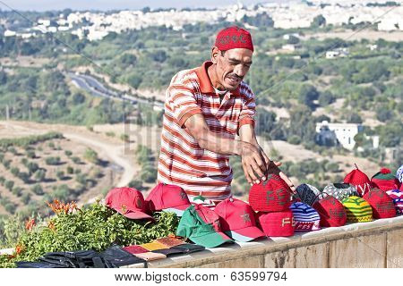FES, MOROCCO - OCTOBER 17, 2013 Moroccan trader with his handmade merchandise in Fes Morocco