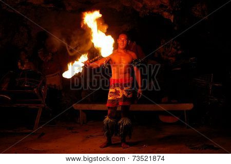 TONGATAPU, TONGA - NOVEMBER 13: An unidentified man performs fire dance (blurred motion) in Hina cav