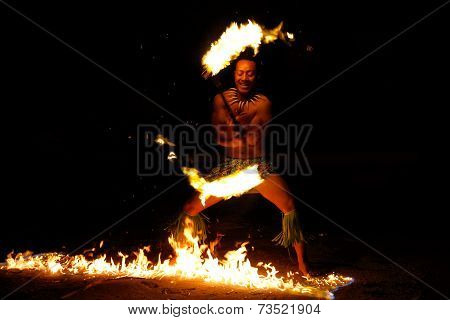TONGATAPU, TONGA - NOVEMBER 13: An unidentified man performs fire dance (blurred motion) in Hina cav