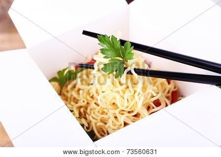 Chinese noodles in takeaway box closeup