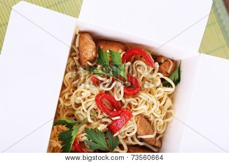 Chinese noodles in takeaway box closeup