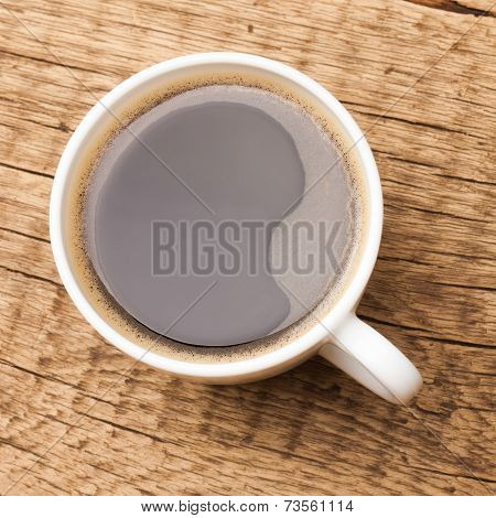 Coffee In White Ceramic Cup On Wooden Table